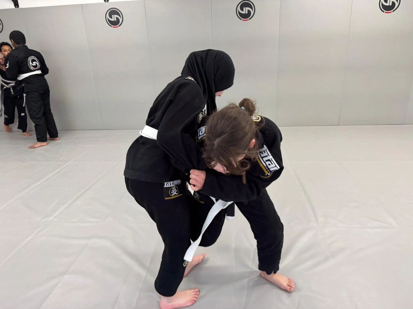 Kids BJJ students practising a technique