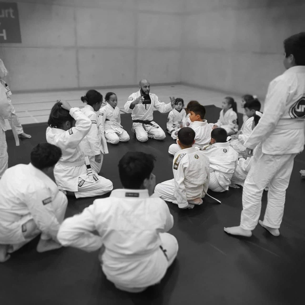 Javed coaching a kids' class at Grapplers Den